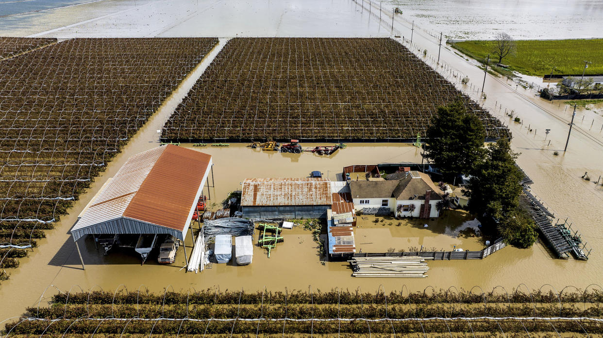 Floodwaters surround a home in Pajaro, Calif., on March 13, 2023. (Noah Berger / AP file)