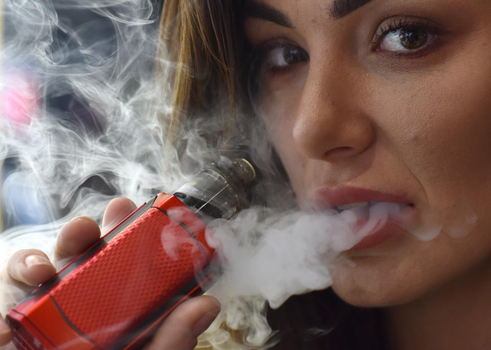 LONDON, ENGLAND - APRIL 12: Promotional person vapes on the Reds, Ejuice stand during Vape Jam 2019 at ExCel on April 12, 2019 in London, England. Vape Jam UK, the premier Electronic Cigarette and E-Liquid trade show brings key industry players, leading manufacturers, consumers, hobbyists and people looking for an alternative to tobacco. (Photo by John Keeble/Getty Images)