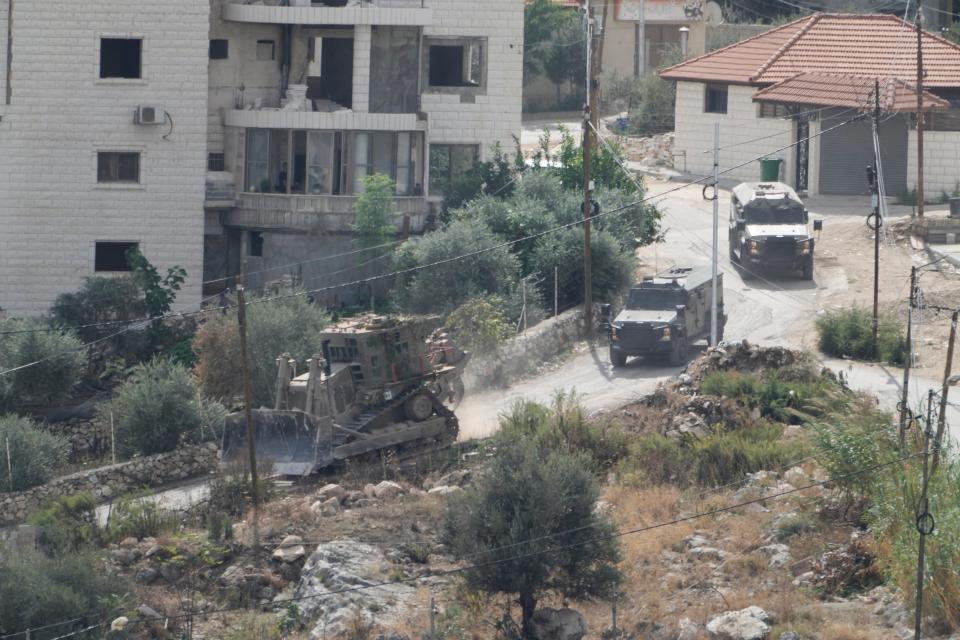 Israeli military vehicles are seen during a raid on Nur Shams refugee camp in the West Bank (Copyright 2023 The Associated Press. All rights reserved.)