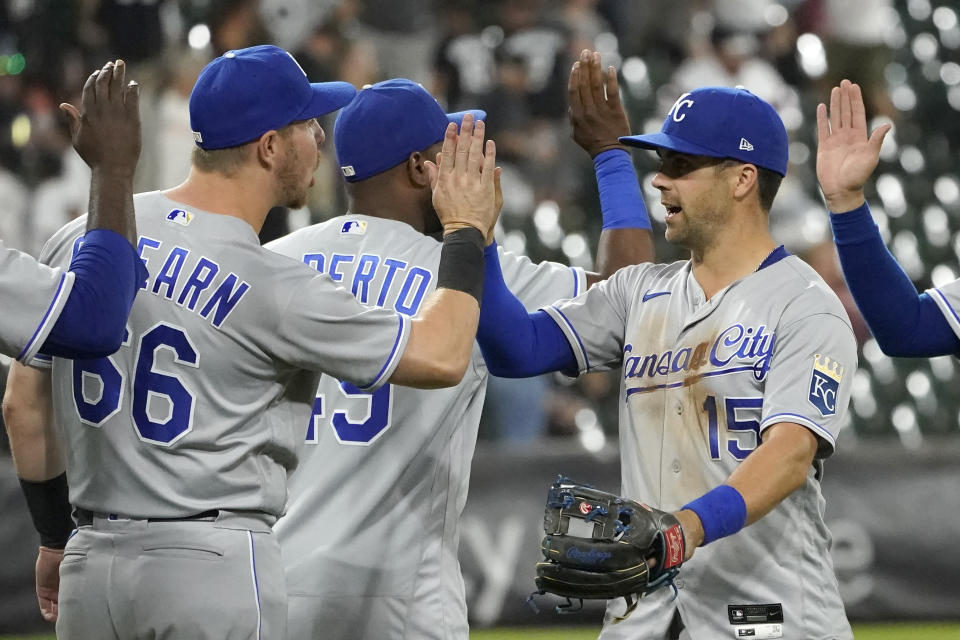 Kansas City Royals' Ryan O'Hearn (66) and Whit Merrifield (15) celebrate the team's 9-1 win over the Chicago White Sox after a baseball game Wednesday, Aug. 4, 2021, in Chicago. (AP Photo/Charles Rex Arbogast)