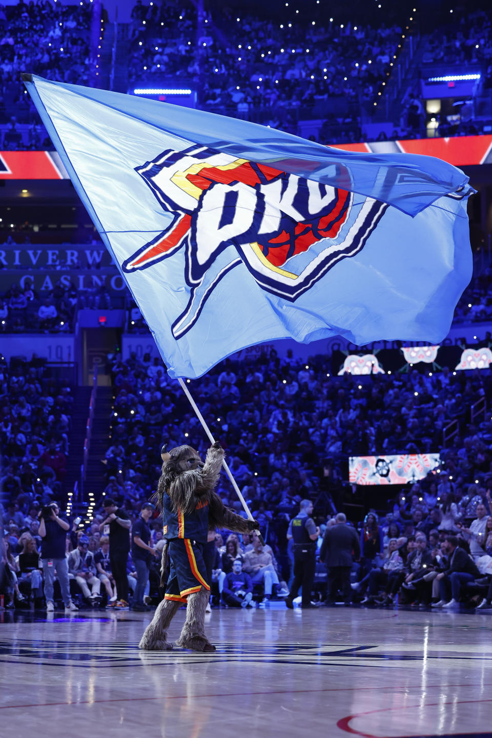 Dec 31, 2023; Oklahoma City, Oklahoma, USA; Oklahoma City Thunder Mascot Rumble the Bison waves a giant flag during a time out against the Brooklyn Nets in the second half at Paycom Center. Mandatory Credit: Alonzo Adams-USA TODAY Sports