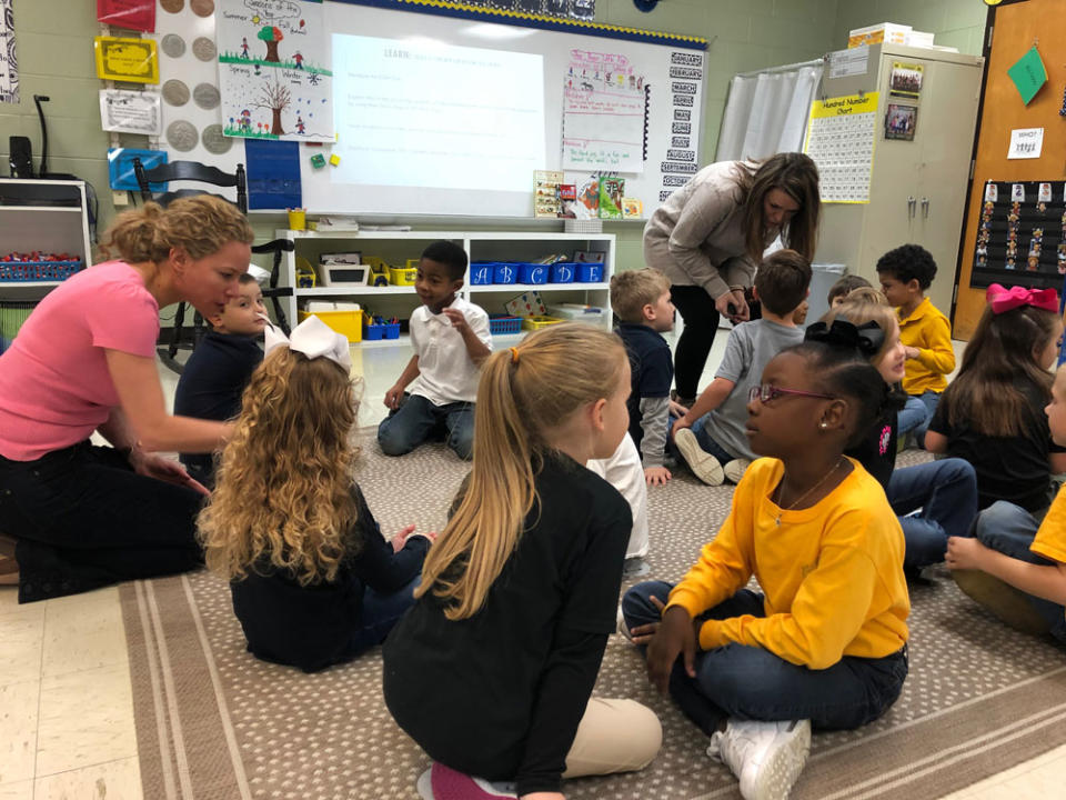 Karen Vaites, left, a literacy expert, visited a kindergarten class in Tennessee’s Lauderdale County Schools as part of a school tour with the Knowledge Matters Campaign, a nonprofit that reviews curriculum to determine if it builds students’ background knowledge. (Courtesy of Karen Vaites)