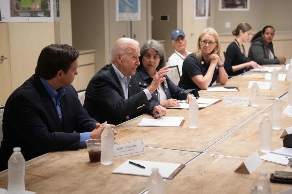 President Joe Biden speaks alongside Miami-Dade County Mayor Daniella Levine Cava, center, and Florida Gov. Ron DeSantis, left, about the collapse of the 12-story Champlain Towers South condo building in Surfside, during a briefing in Miami Beach, Florida on July 1, 2021.