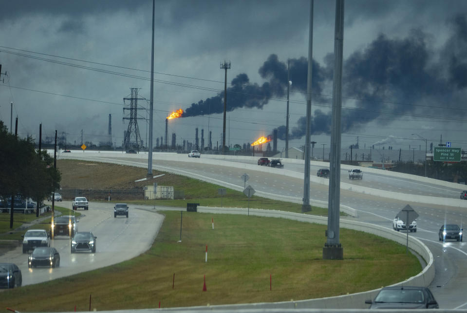 Flares burn at refineries east of the Sam Houston Parkway where a tornado was reported to pass along Mickey Gilley Boulevard near Fairmont Parkway, Tuesday, Jan. 24, 2023, in Pasadena, Texas. (Mark Mulligan/Houston Chronicle via AP)