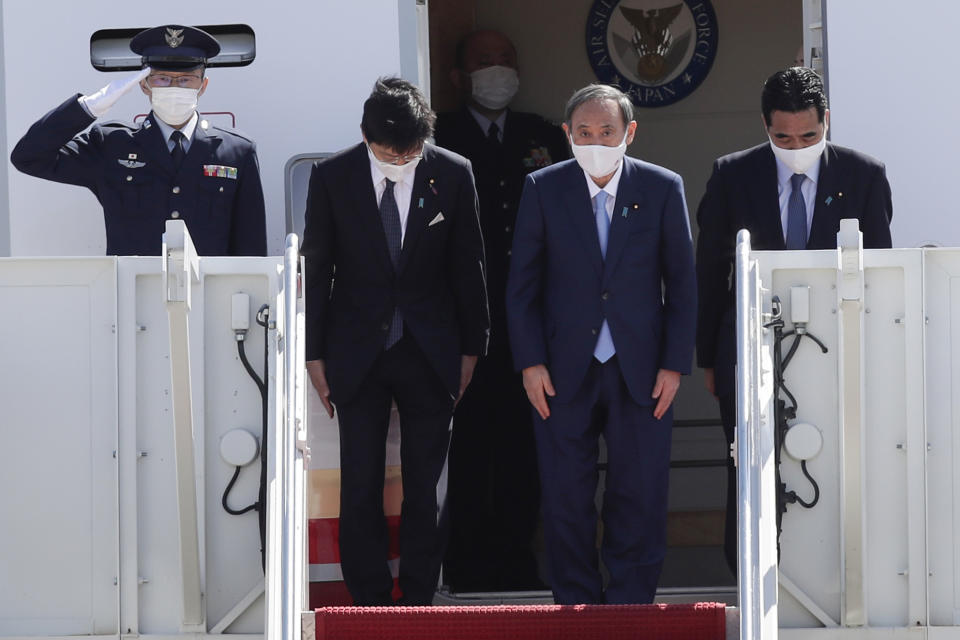 Japanese Prime Minister Yoshihide Suga boards his plane to depart at Andrews Air Force Base, Md., Saturday, April 17, 2021, after his visit to Washington. (AP Photo/Luis M. Alvarez)