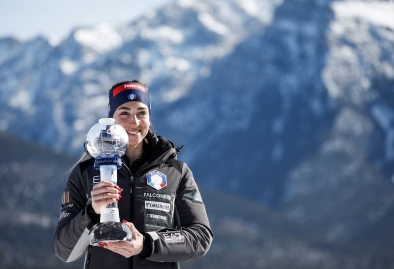 Italian biathlete Lisa Vittozzi holds the crystal globe following the women's World Cup biathlon 10 km pursuit event in Canmore. Jeff Mcintosh/Canadian Press via ZUMA Press/dpa