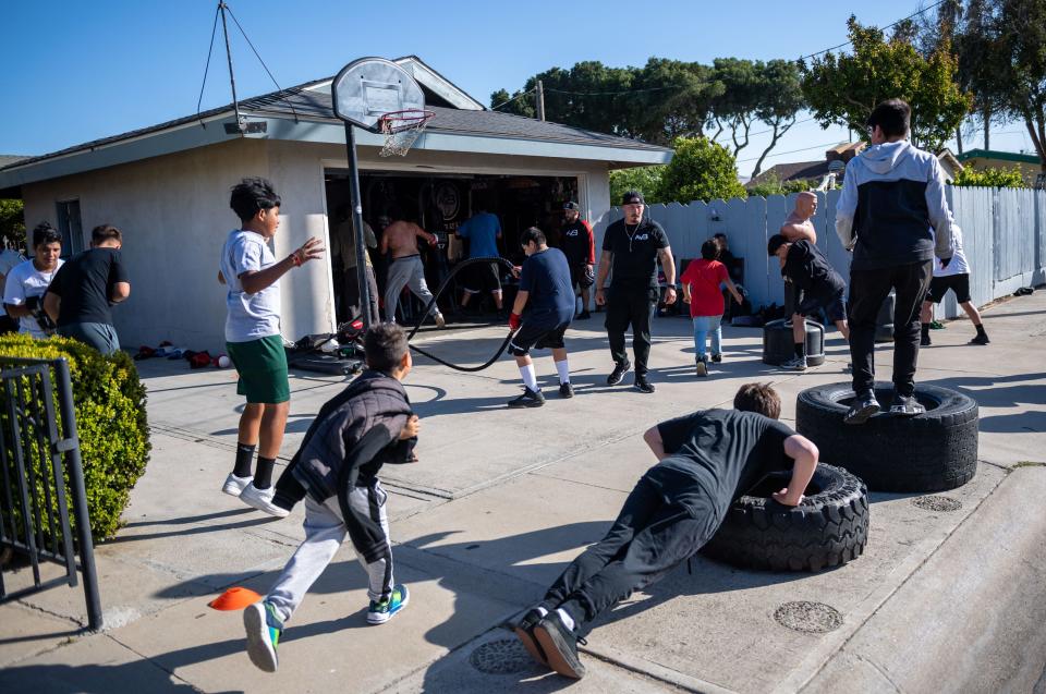 Rigo Avila founder of A.V.I.L.A Victory Boxing walks through over a dozen children of all ages training in Greenfield on May 4. A.V.I.L.A Victory Boxing's mission is to build, promote, and nurture a positive outlook through physical training programs for all youth and adults in South County, primarily in Greenfield.