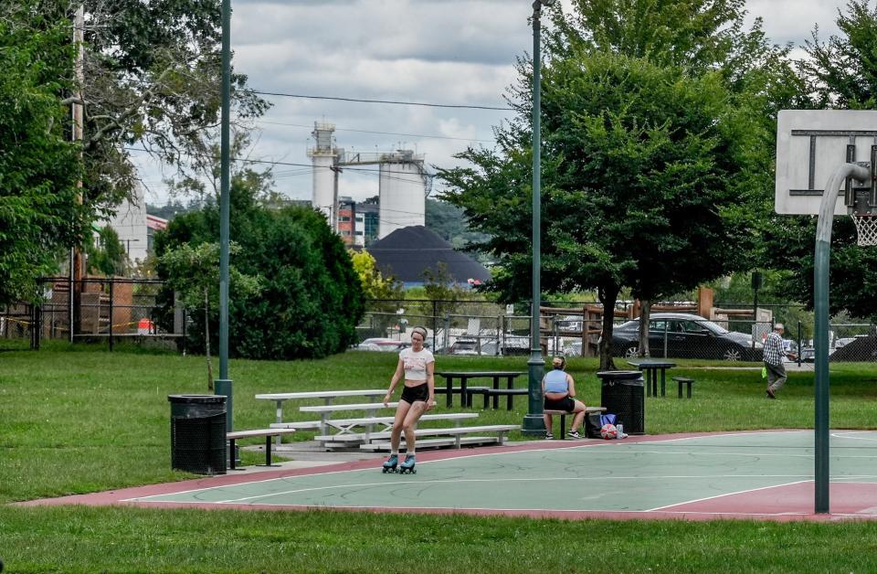 The nearby Port of Providence looms behind Columbia Park in the city's Washington Park neighborhood, where residents struggle with poor air quality and high asthma rates.