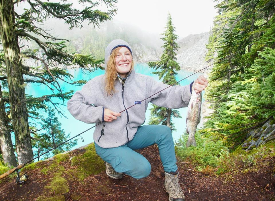 Kayla Sulak after catching a fish in a mountain lake.