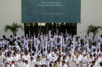 Supporters of the ruling People's Action Party (PAP) wait for their leaders at an elections nomination center Wednesday April 27, 2011 in Singapore. (AP Photo/Wong Maye-E)