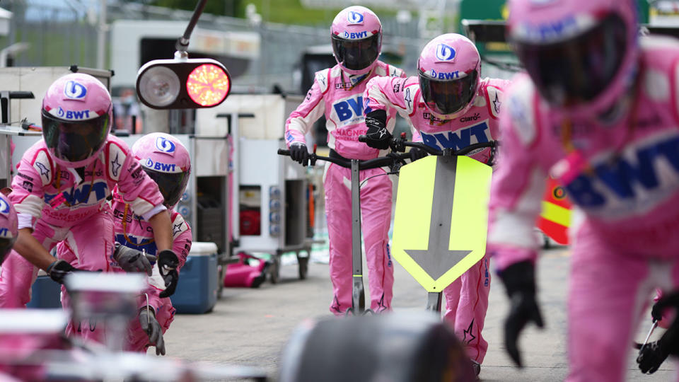 Pictured here, Racing Point team members assemble in the pit stop.