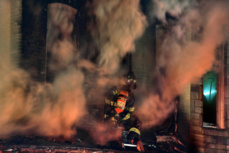 BALTIMORE, MD- APRIL 27: Fireman battled a fire at N. Mount St. and Baker St. that involved several buildings late Monday night. (Photo by Michael S. Williamson/The Washington Post via Getty Images)