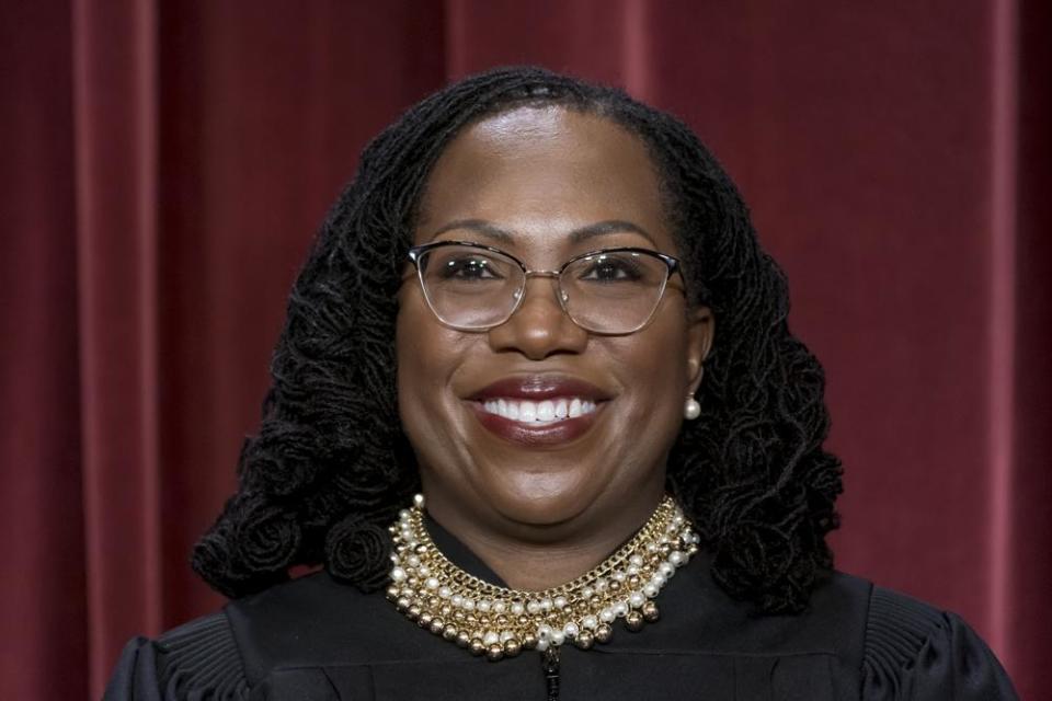 Associate Justice Ketanji Brown Jackson stands as she and members of the Supreme Court pose for a new group portrait following her addition, at the Supreme Court building in Washington, Friday, Oct. 7, 2022. (AP Photo/J. Scott Applewhite)