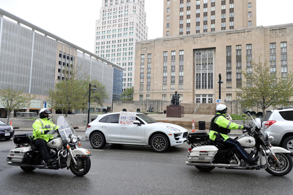 KANSAS CITY, MISSOURI - APRIL 20:  Protesters drive past City Hall encouraging Mayor Quinton Lucas to open businesses up, allow people to work, and return lives to normal on April 20, 2020 in Kansas City, Missouri. The protest was part of a growing national movement against stay-at-home orders designed to slow the spread of the coronavirus. (Photo by Jamie Squire/Getty Images)