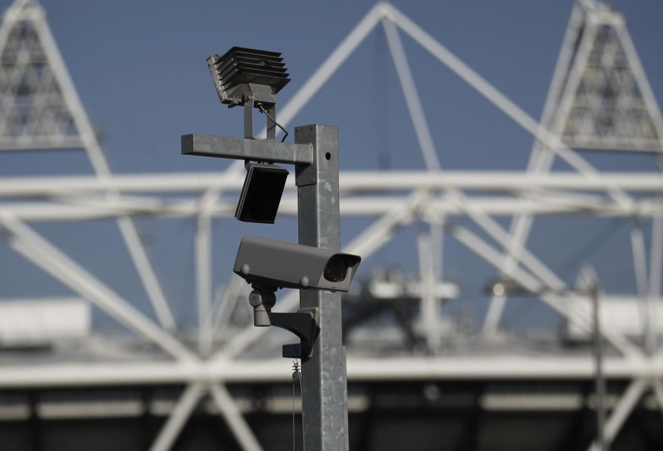 FILE - In this file photo dated Wednesday, March 28, 2012, a security cctv camera is seen by the Olympic Stadium at the Olympic Park in London. The South Wales police deployed facial recognition surveillance equipment on Sunday Jan. 12, 2020, in a test to monitor crowds arriving for a weekend soccer match in real-time, that is prompting public debate about possible aggressive uses of facial recognition in Western democracies, raising questions about human rights and how the technology may enter people's daily lives in the future. (AP Photo/Sang Tan, FILE)