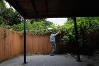 MIAMI, FL - SEPTEMBER 15: Dr. Keith Richardson, Florida Department of Agriculture, looks for Giant African land snails as he works on eradicating a population of the invasive species in Miami-Dade County on September 15, 2011 in Miami, Florida. The Giant African land snail is one of the most damaging snails in the world because they consume at least 500 different types of plants, can cause structural damage to plaster and stucco, and can carry a parasitic nematode that can lead to meningitis in humans. The snail is one of the largest land snails in the world, growing up to eight inches in length and more than four inches in diameter. (Photo by Joe Raedle/Getty Images)