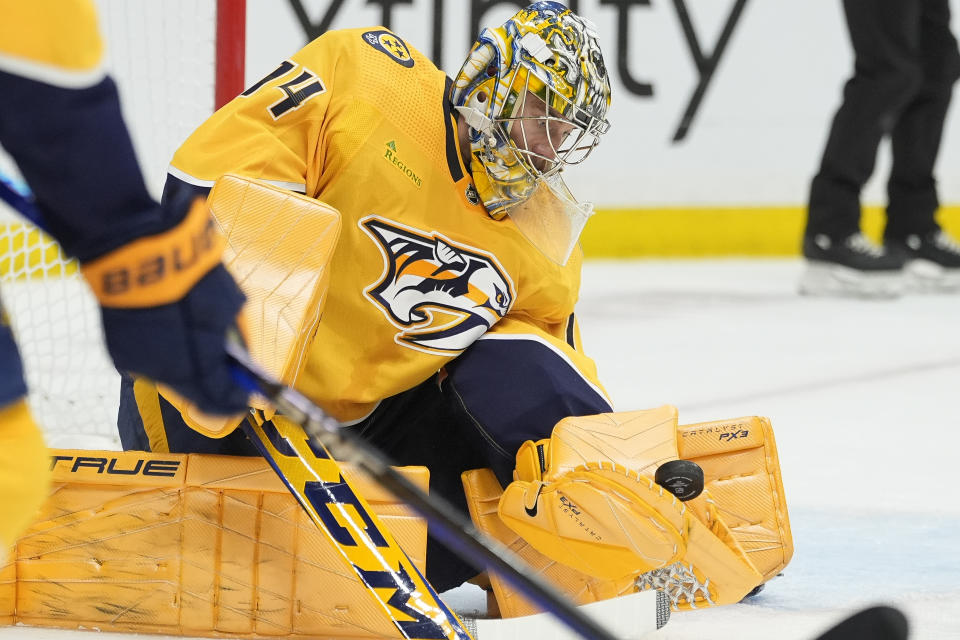 Nashville Predators goaltender Juuse Saros (74) catches a puck during the first period of an NHL hockey game against the Florida Panthers, Monday, Jan. 22, 2024, in Nashville, Tenn. (AP Photo/George Walker IV)