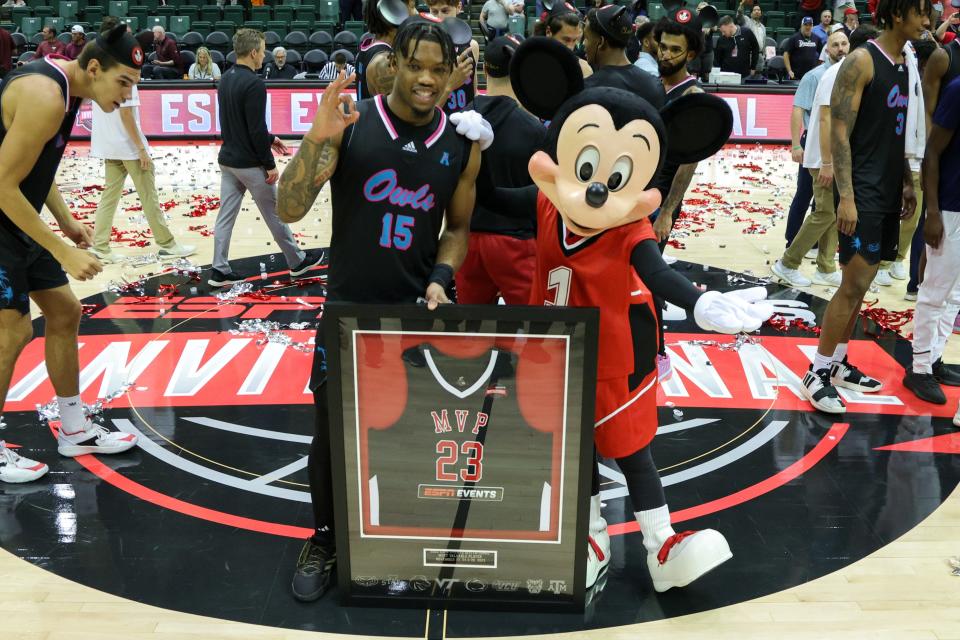 Nov 26, 2023; Kissimmee, FL, USA; Florida Atlantic Owls guard Alijah Martin (15) is presented the MVP award from Mickey Mouse after winning the ESPN Events Invitational Championship game against the Virginia Tech Hokies at State Farm Field House. Mandatory Credit: Nathan Ray Seebeck-USA TODAY Sports