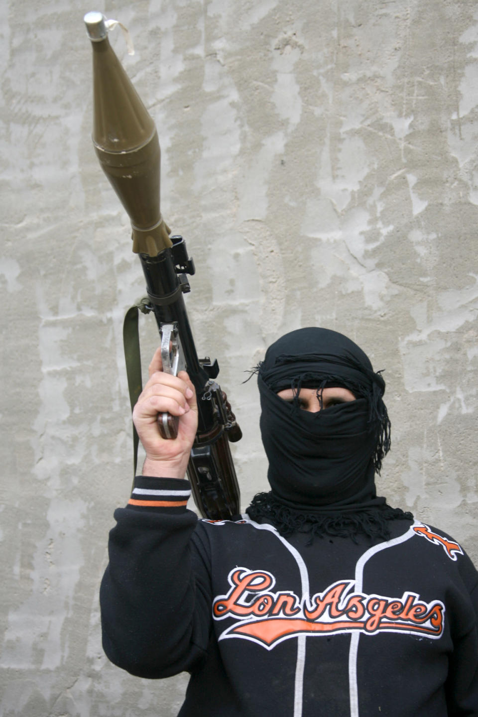 In this Sunday, Jan. 5, 2014 picture, a gunman holds a rocket-propelled grenade during clashes with Iraqi security forces in Fallujah, Iraq. Clashes continued late Sunday and early morning Monday between al-Qaida and Iraqi troops on the main highway that links the capital, Baghdad, to neighboring Syria and Jordan. Al-Qaida fighters and allied tribes are still controlling the center of the city where they are deployed in streets and around government buildings. (AP Photo)