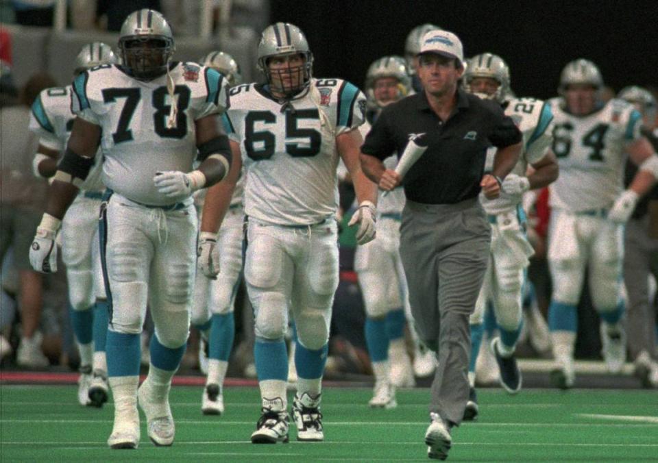 Carolina Panthers head coach Dom Capers leads his team onto the Georgia Dome field Sunday before Carolina’s first-ever regular-season game, in 1995. The Panthers lost, 23-20.