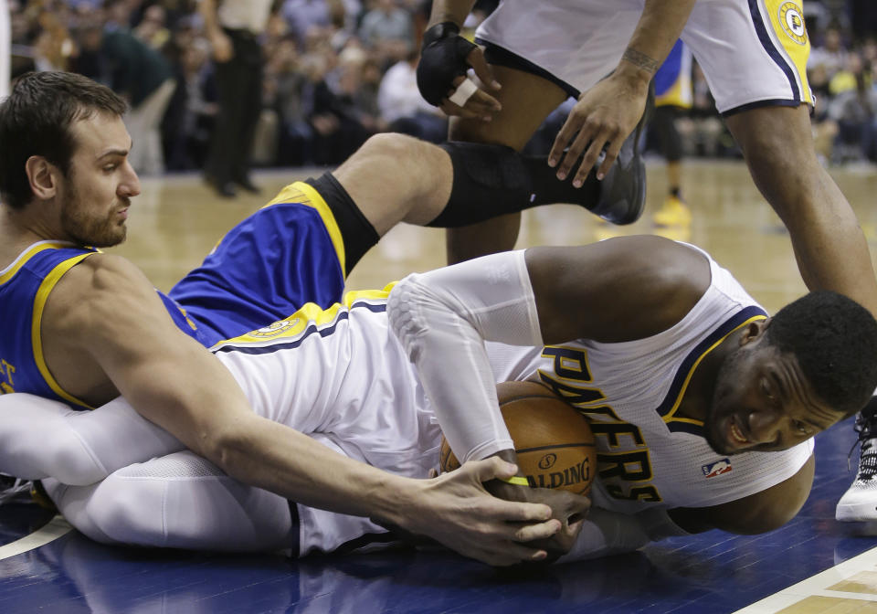 Indiana Pacers' Roy Hibbert, right, battles for a loose ball against Golden State Warriors' Andrew Bogut during the first half of an NBA basketball game Tuesday, March 4, 2014, in Indianapolis. (AP Photo/Darron Cummings)