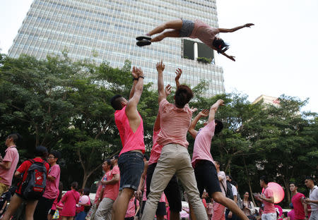 Participants dressed in pink perform cheerleading stunts before taking part in the forming of a giant pink dot at the Speakers' Corner in Hong Lim Park in Singapore June 28, 2014. The annual Pink Dot Sg event promotes an acceptance of the Lesbian, Gay, Bisexual and Transgender (LGBT) community in Singapore, according to organizers. REUTERS/Edgar Su/File Photo