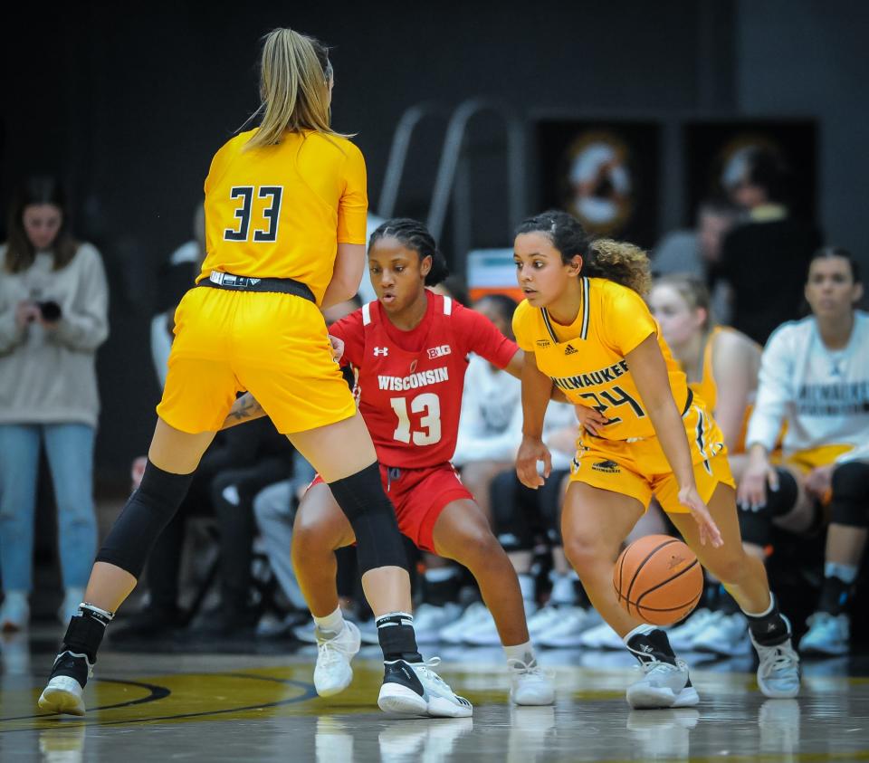 Wisconsin guard Ronnie Porter fights through a pick by UW-Milwaukee center Megan Walstad to stay with Jada Donaldson in a game in November.
