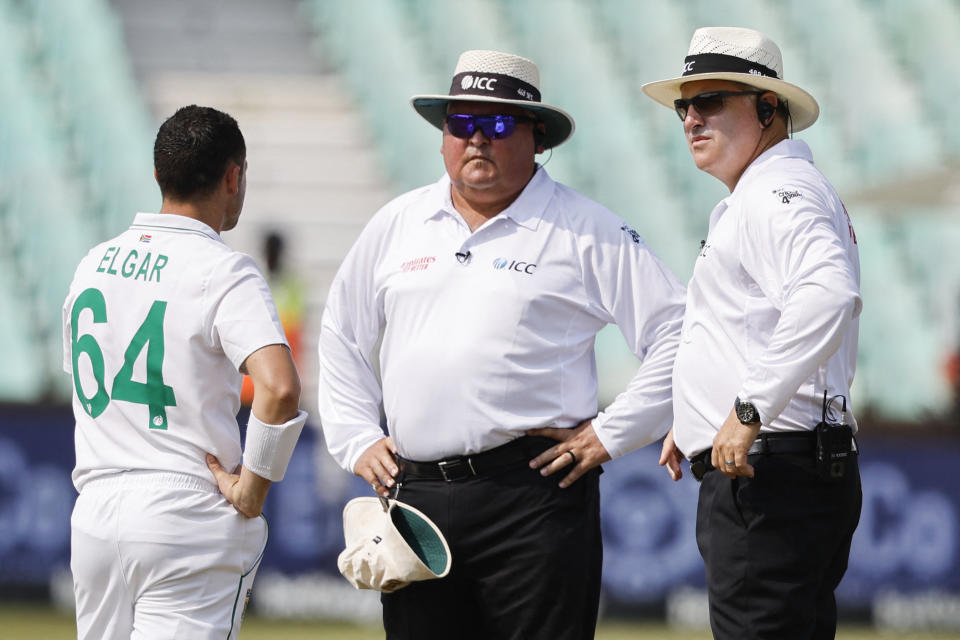 From left to right, South Africa's Dean Elgar talks to South African umpires Marais Erasmus and Adrian Holdstock during first Test against Bangladesh in Durban. 