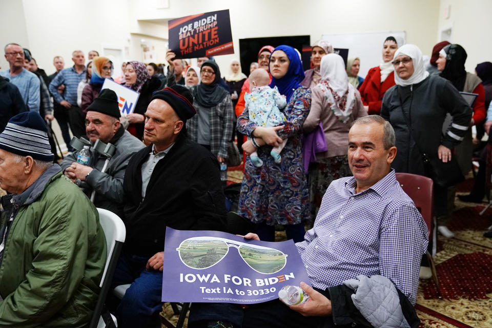 Participants hold campaign signs for Vice President Joe Biden during the first-in-the-nation Iowa caucus at the Islamic and Education Center Ezan mosque in Des Moines, Iowa on Feb. 3, 2020.