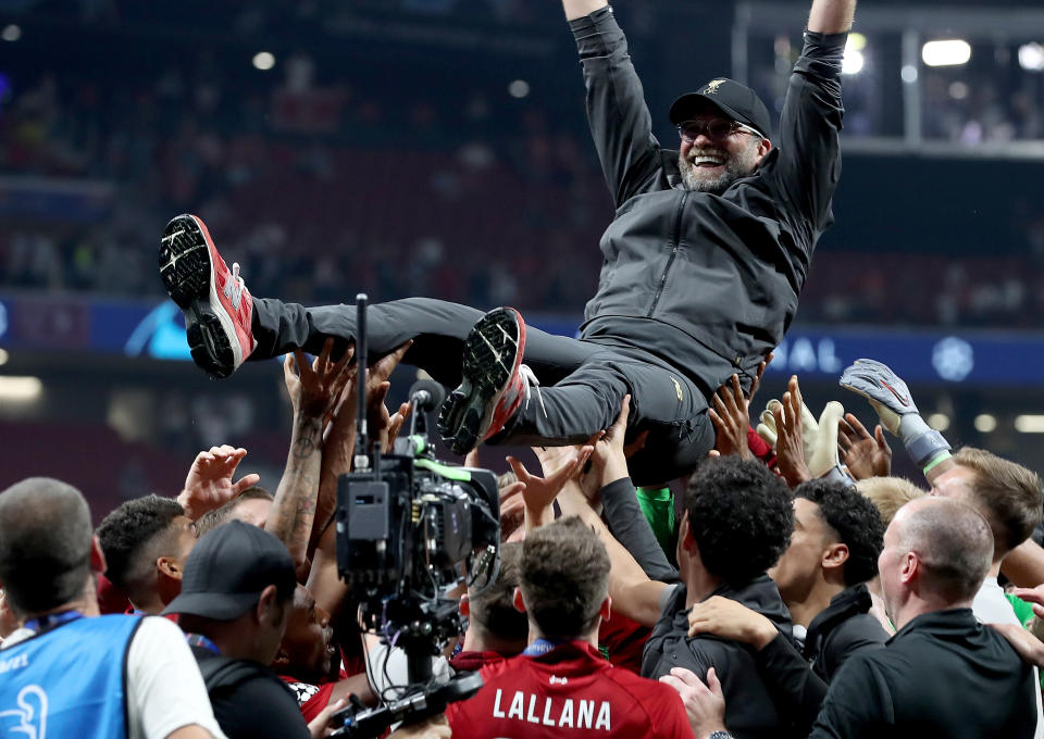 Liverpool manager Jurgen Klopp is lifted up by his players after winning the UEFA Champions League Final at the Wanda Metropolitano, Madrid.