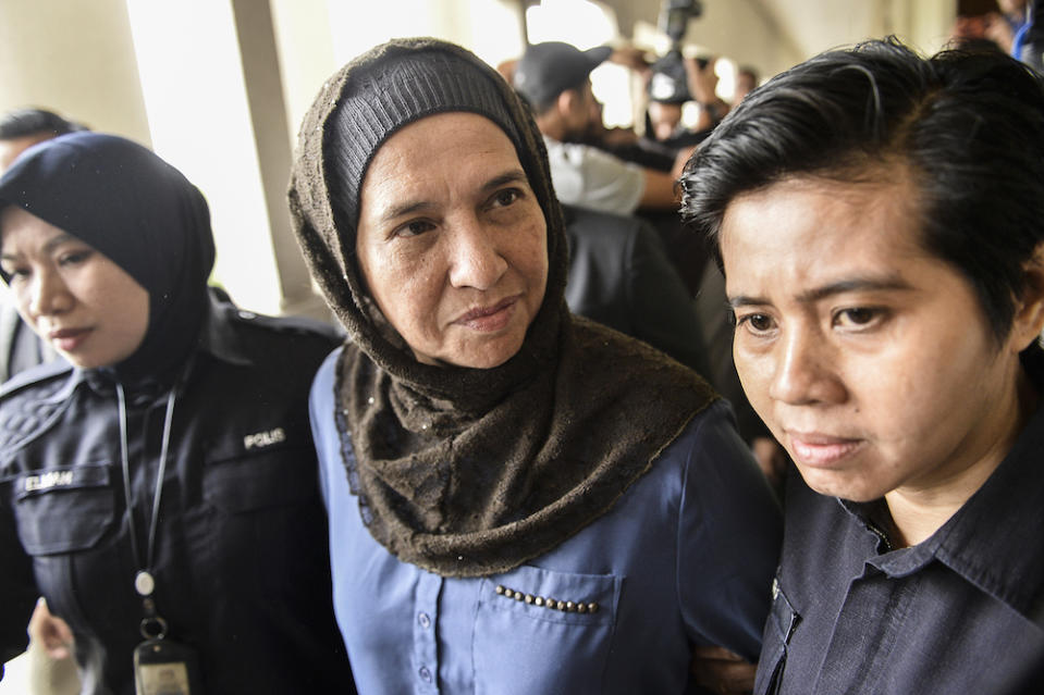 Former Companies Commission of Malaysia (SSM) CEO, Datuk Zahrah Abd Wahab Fenner, is escorted by police at the Kuala Lumpur Sessions Court October 2, 2019. — Picture by Miera Zulyana