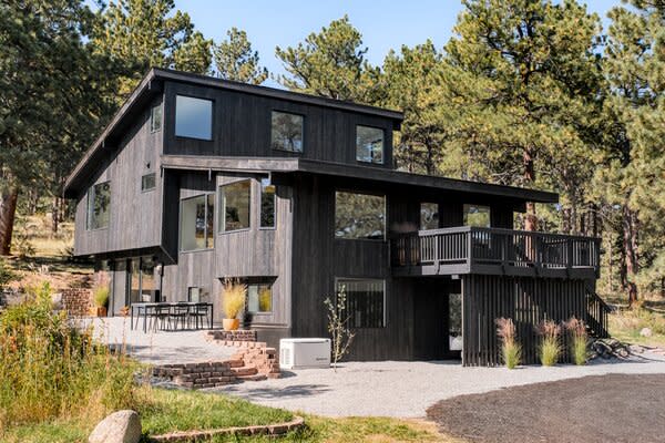 The multi-level home radiates contemporary flair with its sleek black exterior.