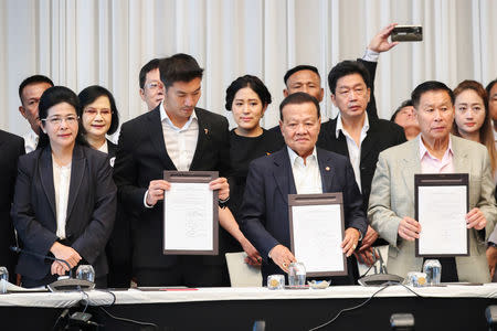 Sudarat Keyuraphan, Pheu Thai Party's prime ministerial candidate (L), Thanathorn Juangroongruangkit, leader of the Future Forward Party (2L), and leaders of other parties hold up agreements during a news conference to form a "democratic front" in Bangkok, Thailand, March 27, 2019. REUTERS/Athit Perawongmetha