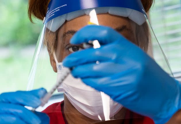 A woman prepares a COVID-19 vaccination at a vaccination clinic in Fairfax, Virginia, on May 13, 2021. (Photo: ANDREW CABALLERO-REYNOLDS via Getty Images)