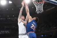 New York Knicks forward Kevin Knox II (20) stops Denver Nuggets forward Juan Hernangomez (41) from scoring during the first half of an NBA basketball game Thursday, Dec. 5, 2019, at Madison Square Garden in New York. (AP Photo/Mary Altaffer)