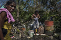 Residents shower and clean up after losing their home to Hurricane Otis in Acapulco, Mexico, Friday, Oct. 27, 2023. Hundreds of thousands of people's lives were torn apart when the fastest intensifying hurricane on record in the Eastern Pacific shredded the coastal city of 1 million. (AP Photo/Felix Marquez)