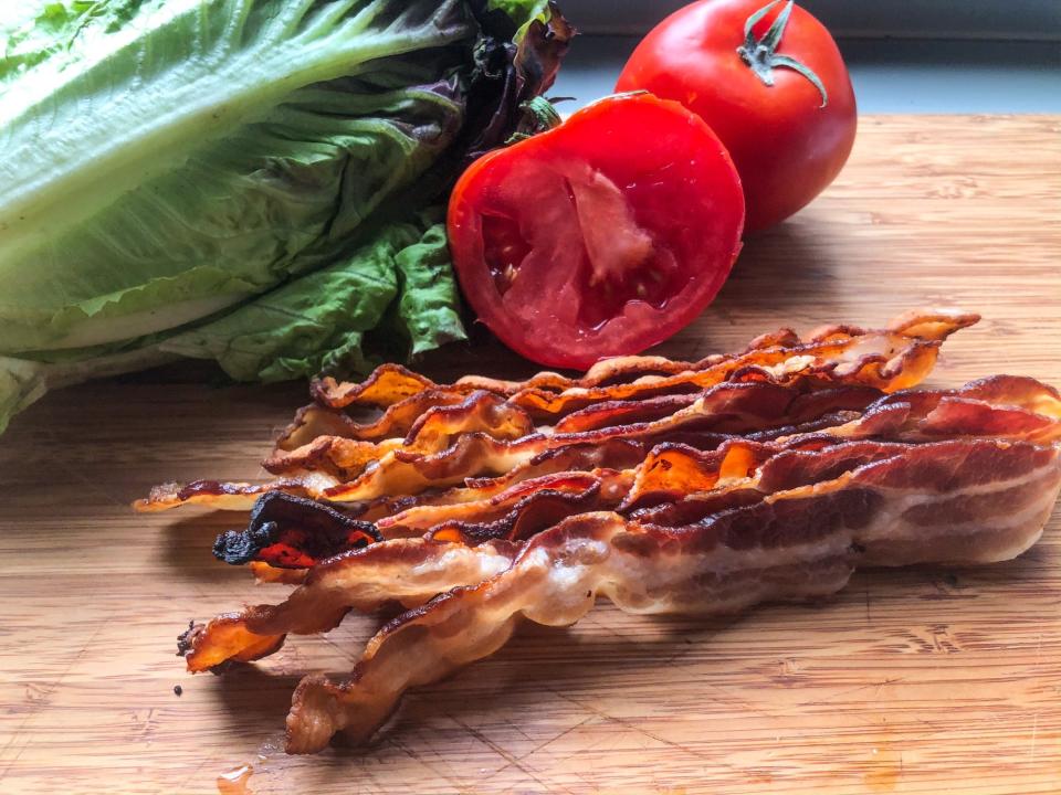 bacon lettuce and tomato on wooden board