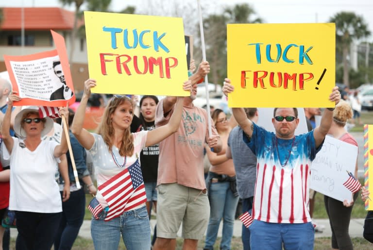 Protesters demonstrate outside a rally by US President Donald Trump at the Orlando Melbourne International Airport in Florida