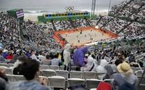 2016 Rio Olympics - Beach Volleyball - Men's Preliminary - Beach Volleyball Arena - Rio de Janeiro, Brazil - 10/08/2016. Fans watch beach volleyball on a rainy day. REUTERS/Ricardo Moraes