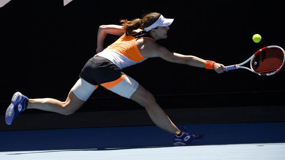 Alize Cornet of France plays a backhand return to Tamara Zidansek of Slovenia during their third round match at the Australian Open tennis championships in Melbourne, Australia, Saturday, Jan. 22, 2022. (AP Photo/Andy Brownbill)