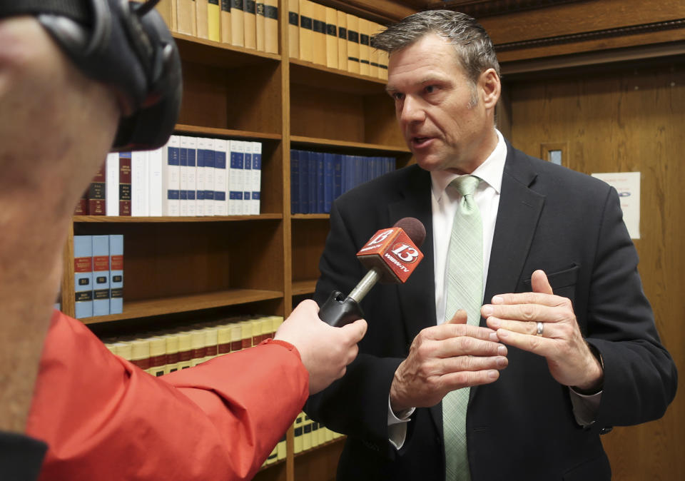 FILE - In this Nov. 30 2018 file photo, former Kansas Secretary of State Kris Kobach answers questions from reporters in Topeka, Kan. The future of a contentious multi-state voter registration database is uncertain now that former Kansas Secretary of State Kobach no longer holds that office. A spokeswoman for Kansas Secretary of State Scott Schwab said Friday, Jan. 18, 2019, the office is reviewing Interstate Voter Registration Crosscheck Program and consulting with other member states. (AP Photo/John Hanna File)