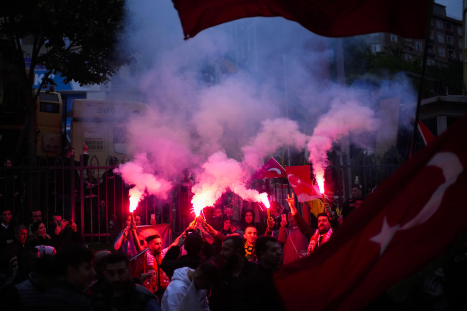 Supporters of President Recep Tayyip Erdogan cheer outside AKP (Justice and Development Party) headquarters in Istanbul, Turkey, Sunday, May 14, 2023. More than 64 million people, including 3.4 million overseas voters, were eligible to vote. (AP Photo/Francisco Seco)