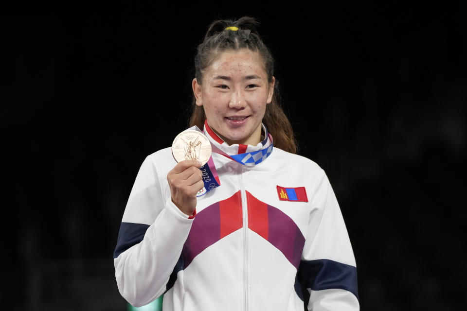 Mongolia's Bolortuya Bat Ochir shows her bronze medal during the victory ceremony for the women's freestyle 53kg wrestling at the 2020 Summer Olympics, Friday, Aug. 6, 2021, in Chiba, Japan. (AP Photo/Aaron Favila)