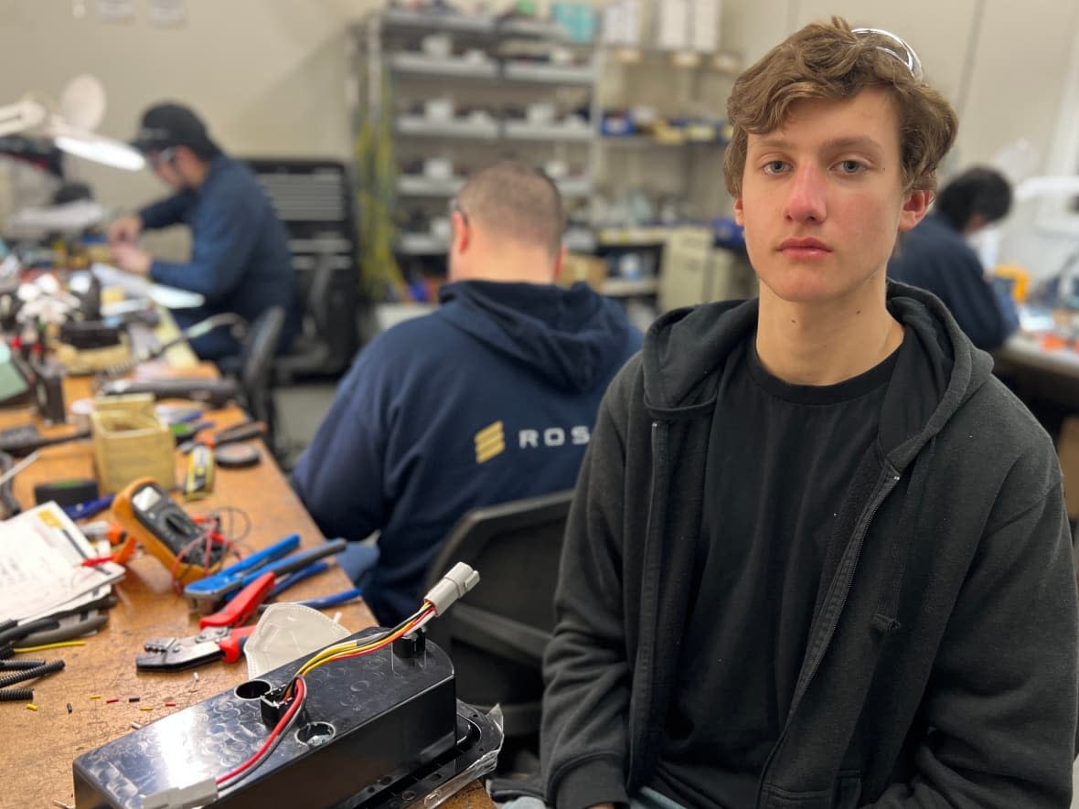 Vladyslav Utkin, 17, is among the displaced Ukrainians who found work at the Roshel plant in Mississauga, Ont. He says working with others from his country makes communicating easier.  (Megan McCleister/CBC - image credit)