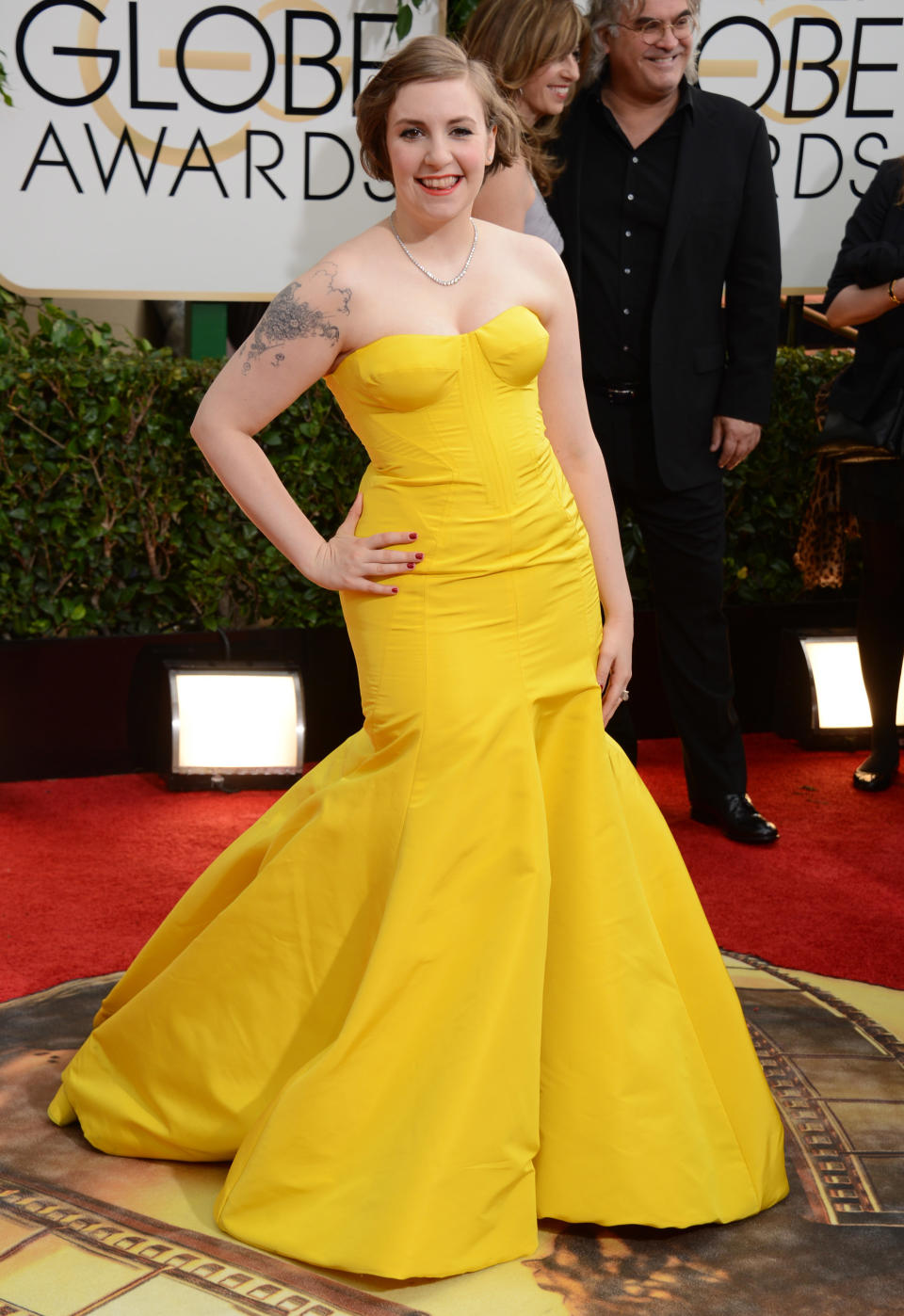 Lena Dunham/Grade D+: The "Girls" co-showrunner tried really hard to work the red carpet in this bright yellow, strapless Zac Posen gown, but as Dunham told Ryan Seacrest herself, "None of this is quite right on me." (Photo by Jordan Strauss/Invision/AP)