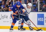 Apr 1, 2019; Uniondale, NY, USA; Toronto Maple Leafs left wing Tyler Ennis (63) and New York Islanders left wing Matt Martin (17) battle for the puck during the third period at Nassau Veterans Memorial Coliseum. Mandatory Credit: Dennis Schneidler-USA TODAY Sports