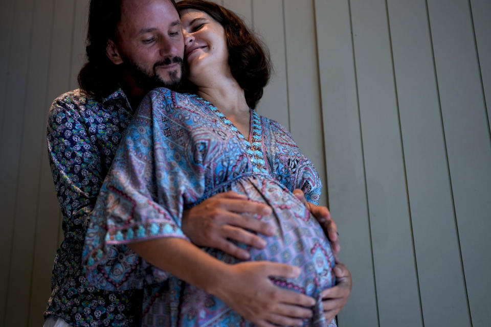 Parents-to-be Maxim Levoshin and Ekaterina Gordienko, pose for a picture in Buenos Aires, Argentina, Tuesday, Feb. 7, 2023. Gordienko, a 30-year-old Russian psychologist arrived in the Argentine capital in December with her 38-year-old husband. (AP Photo/Natacha Pisarenko)