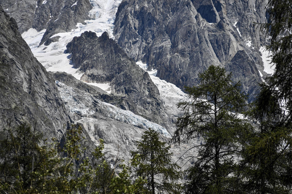 The Planpincieux glacier, located in the Alps on the Grande Jorasses peak of the Mont Blanc massif, is seen from Val Ferret, a popular hiking area on the south side of the Mont Blanc, near Courmayeur, northern Italy, Friday, Aug. 7, 2020. Some 70 people were evacuated Thursday in the valley below the glacier and roads closed after the threat of collapse the the fast-moving melting glacier is posing to the picturesque valley near the Alpine town of Courmayeur. (Claudio Furlan/LaPresse via AP)