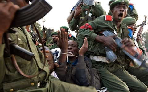 A prisoner with bound wrists pleads while being beaten by government soldiers just outside Goma in eastern Congo, November 23, 2008 - Credit: Reuters