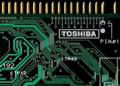 FILE PHOTO: A logo of Toshiba Corp is seen on a printed circuit board in this photo illustration taken in Tokyo July 31, 2012.   REUTERS/Yuriko Nakao/File Photo